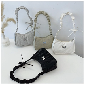 Detail showing various colors of butterfly shoulder bags with ruched handles and metal logos