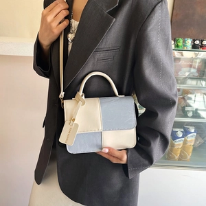 Fashionable blue and beige patchwork leather crossbody handbag with stylish chain handle