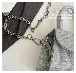 Detail of silver glitter mini bag with detachable metal chain strap and top handle