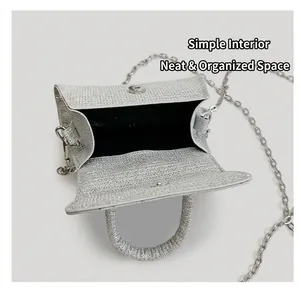 Detail view of silver sequin handbag showing black inner lining and magnetic snap closure