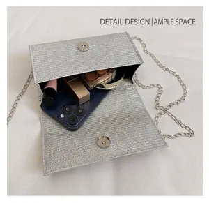 Silver sequin clutch bag detail showing spacious interior for smartphone and cosmetics