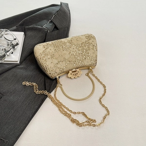 Detail of champagne gold lace evening bag with floral sequins and metal ring handle