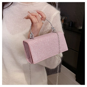 Detail of pink rhinestone evening bag with silver metal handle and chain strap