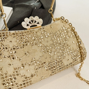 Detail of champagne gold lace evening bag with sequins and crown rhinestone clasp