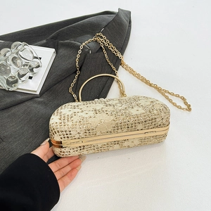 Macro shot of elegant champagne gold floral lace evening clutch with golden chain strap