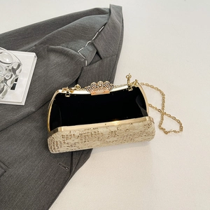 Detail view of the lace evening bag with crown rhinestone clasp and gold chain strap