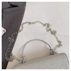 Detailed macro view of silver sequin texture with metal ring handle and chain strap