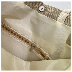 Detail view of linen bag interior featuring a metal zipper pocket and magnetic closure