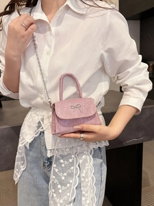 Pink glitter mini handbag with silver bow detail and removable metal chain strap