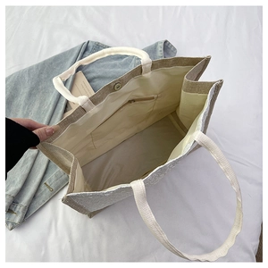 Internal view of canvas tote bag showing magnetic closure, zip pocket and large main space