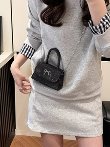 Sparkling black mini handbag with silver bow detail and metal chain strap for women