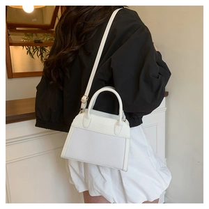 Detail of white PU leather tote with Fashion & Bags embossing and woven texture