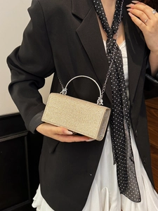 Elegant champagne gold glitter evening bag with silver metal handle and chain strap