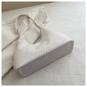 Top view of white woven leather hobo bag with fine texture and slim shoulder strap