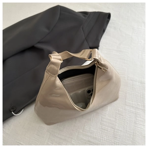 Interior view showing the storage capacity for a smartphone and wallet in the beige bag