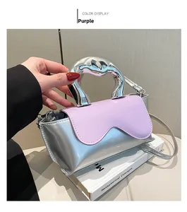 Detail of purple mini bag with liquid-style metal handle and metallic finish