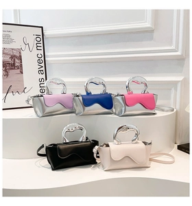 Mini crossbody bags with unique wavy flaps and sculptural silver metal handles in five colors
