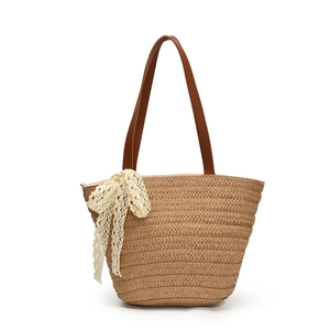 Bohemian striped straw tote bag with large lace bow and leather handles for beach trips