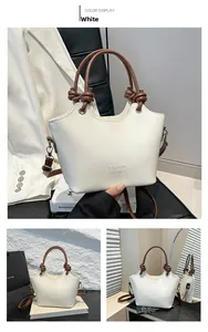 Close-up of cream bucket bag with brown handles and embossed Fashion H.C Bag logo