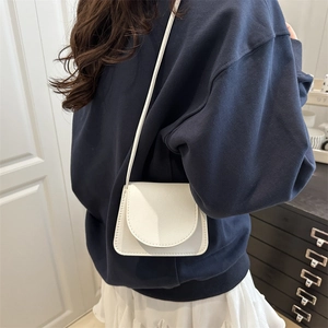 Minimalist white leather mini crossbody bag with litchi texture for fashion styling
