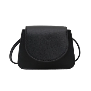 Chic black litchi grain mini crossbody bag with a curved flap and slim leather strap