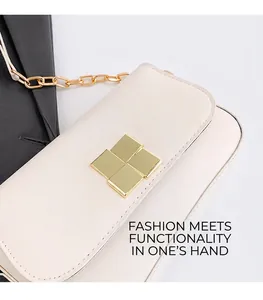 Close-up of cream shoulder bag featuring a gold chain strap and square metal clasp detail