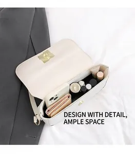Interior view showing the large capacity of the white leather shoulder bag with essentials