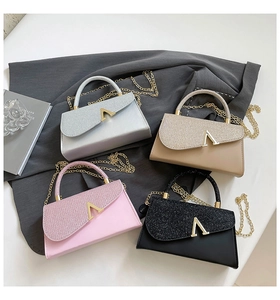 Detailed flat lay of glittering evening clutch bags in silver, gold, pink, and black colors