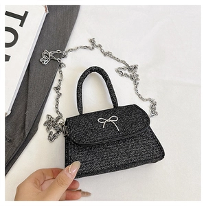Detail of black glitter mini handbag with silver butterfly buckle and chain strap