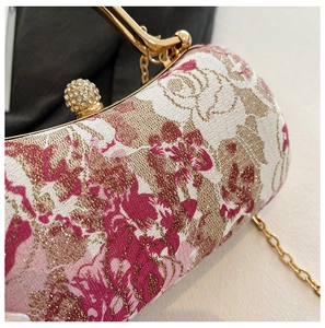 Close-up of pink rose floral embroidery with sparkling crystal ball clasp on clutch
