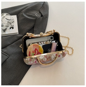 Macro detail of embroidery chain bag showing open interior and floral jacquard texture