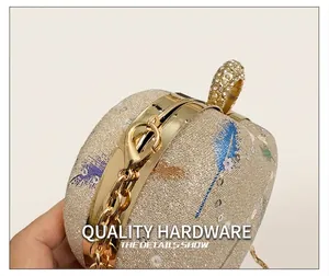 Detailed close-up of golden metal clasp with sparkling rhinestones on sequin handbag
