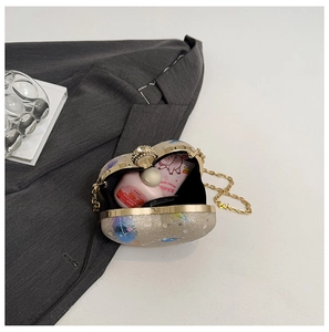 Detail view of glitter evening clutch with diamond ring clasp and interior storage space