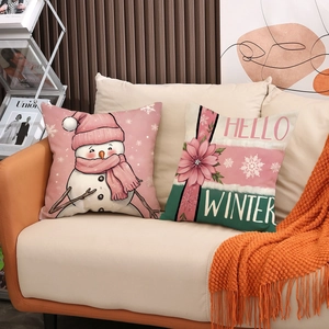 Christmas linen pillow covers with cute snowman and Hello Winter print on a sofa