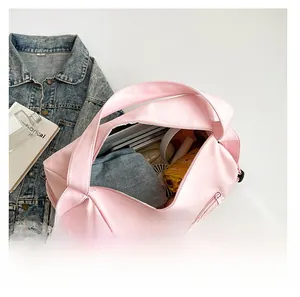 Pink waterproof yoga bag showing large capacity for umbrella and tablet inside