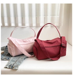 Waterproof travel bags in pink and burgundy with adjustable straps and metal feet