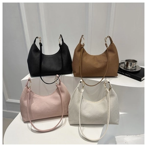 Minimalist hobo bags shown in four colors with textured stripes and gold hardware