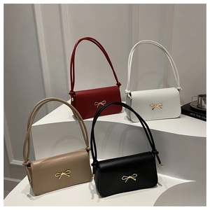 Close-up of four minimalist shoulder bags in burgundy, white, khaki, and black colors