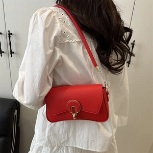 Elegant red leather shoulder bag with a unique round metal buckle and chain strap for women