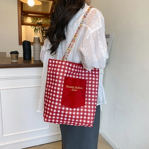 Red and white checkered canvas tote bag with red pocket and unique beaded handles