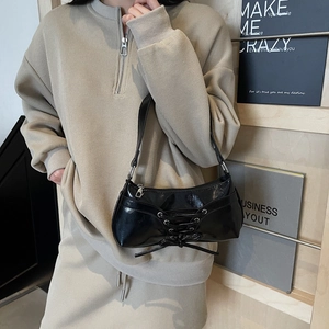 Minimalist black glossy underarm bag with lace-up drawstring design for women