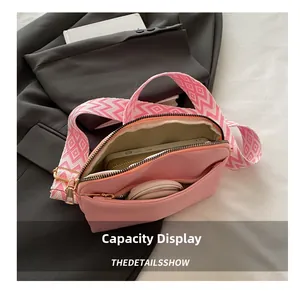 Pink nylon crossbody bag interior showing storage space for phone and cosmetics