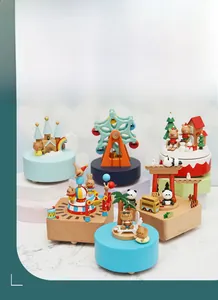 Various wooden music box themes including carousel and circus on marble display