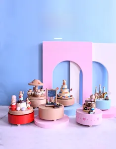 Artistic detail of hand-painted wooden music boxes with animal and castle themes