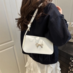 French style white shoulder bag with gold bow ornament and knotted strap detail