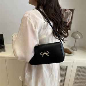 French style black leather underarm bag with elegant gold bow metal accessory