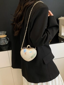Sparkly heart shaped crossbody bag with colorful sequins and elegant gold chain strap
