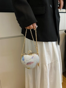 Silver glitter heart-shaped clutch bag with feather pattern and gold chain strap