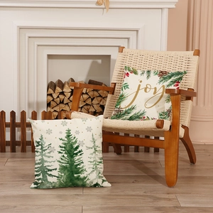 Nordic Christmas pillow covers with watercolor tree and gold joy lettering in cozy home setting