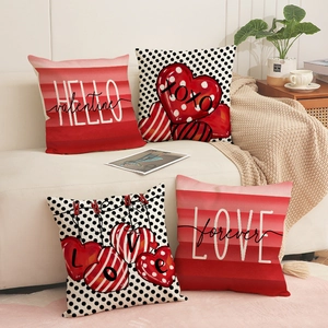 Set of 4 Valentine's Day red pillow covers with heart and letter prints on a beige sofa